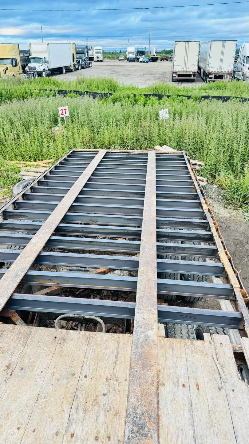 Flatbed trailer frame with new cross members welded in