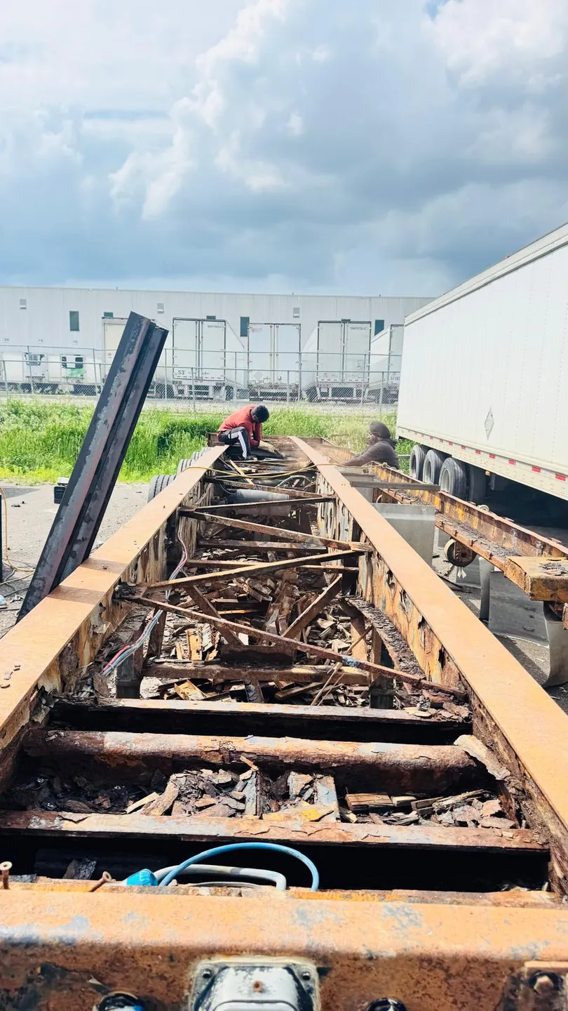 Before: rusted floor and cross members cut out of the trailer
