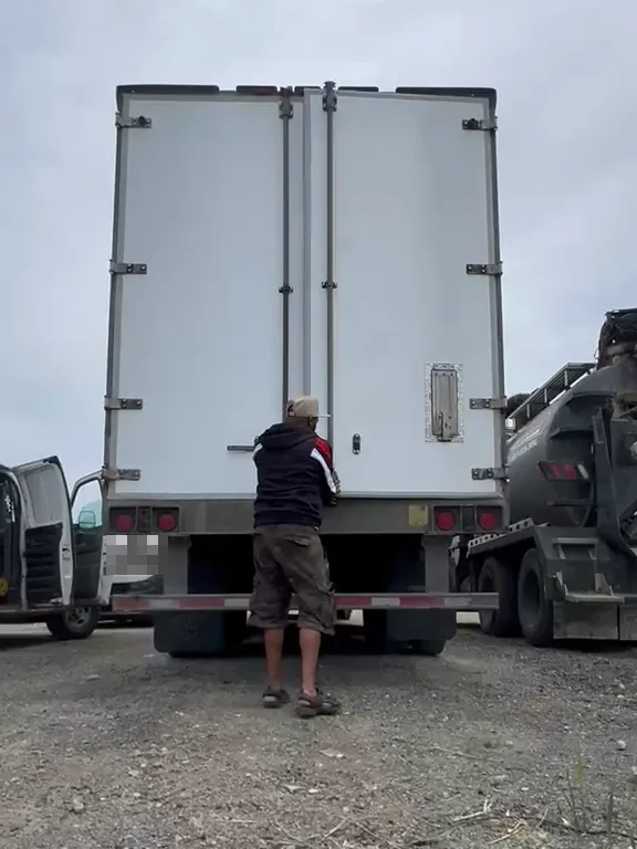 Baaz welder adjusting the rear swing doors of a reefer trailer