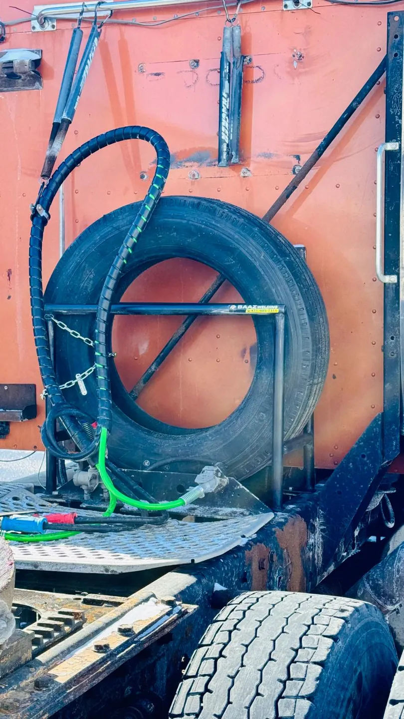 Spare tire carrier built by Baaz Welding on a tractor deck